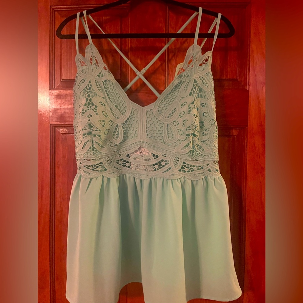 Brand new with tags. Perfectly Priscilla tank with peek a boo middle.   Lace.